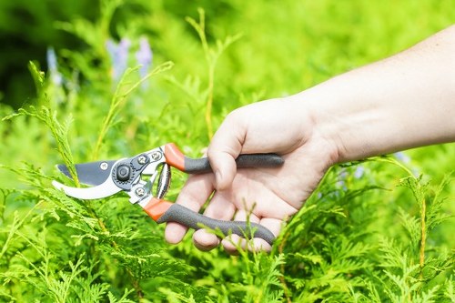 Gardener using high-visibility clothing and safety boots